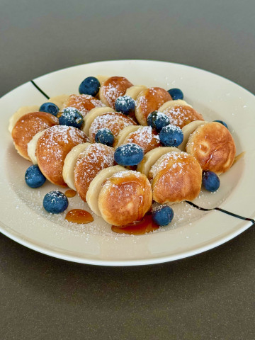 Poffertjes - Dutch mini buckwheat pancakes with banana and blueberries