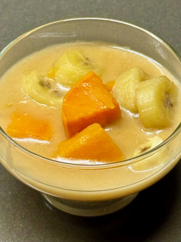 Tropical dessert with sweet potatoes and banana in a coconut sauce - kolak pisang ubi jalar